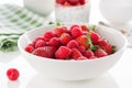 Summer fresh red juicy fruits Ã¢â¬â raspberries and strawberries in a white bowl on a table for breakfast or lunch Royalty Free Stock Photo